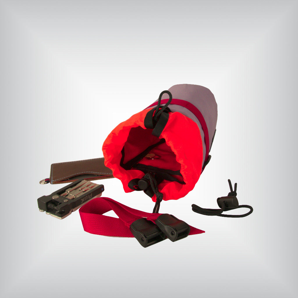 Cycling gear in front of bikepacking feed bag.