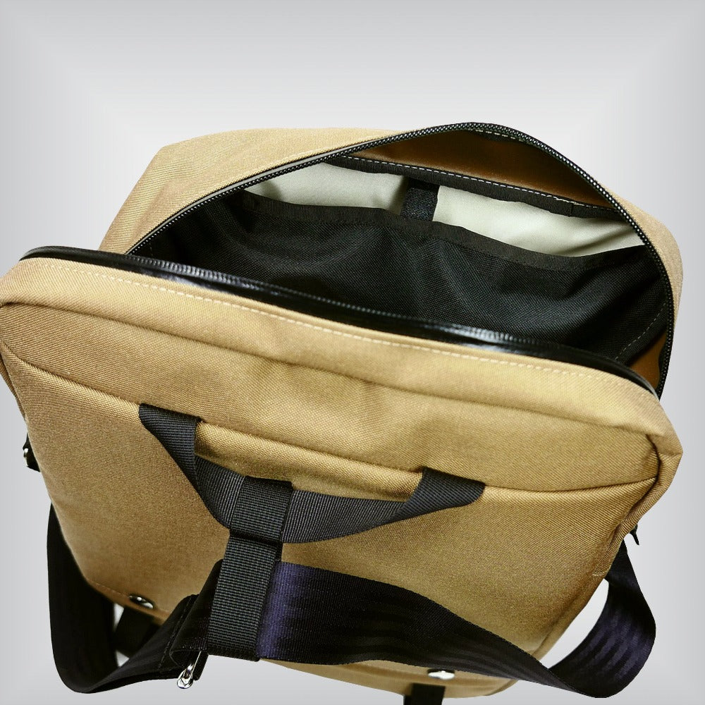Retro-inspired front bag for Brompton bicycle with adjustable strap and double zipper main compartment.