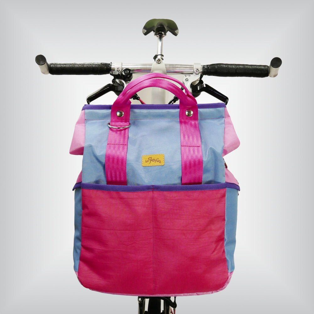 Stylish cycling companion: 'HardCandy' bag for Brompton bikes, boasting 14 liters of pinkalicious space, external/ internal pockets, and a hot pink shoulder strap for a funky and safe ride.