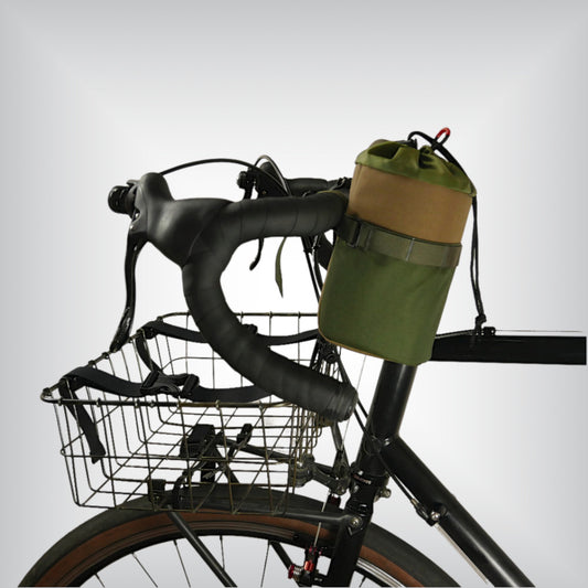 Close-up of the Snack Tank Feed Bag mounted on a bike stem, showing its sturdy construction and practical design.