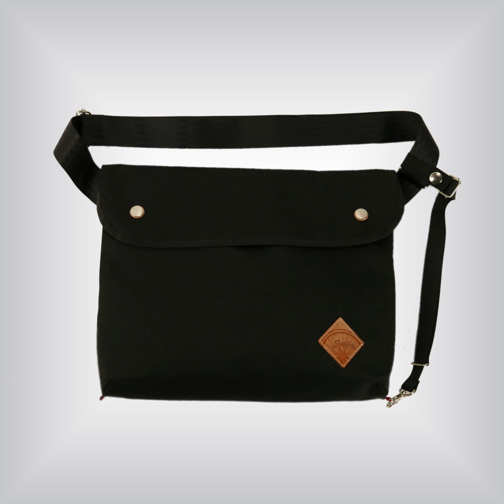 Black cycling messenger bag with stabilising strap.