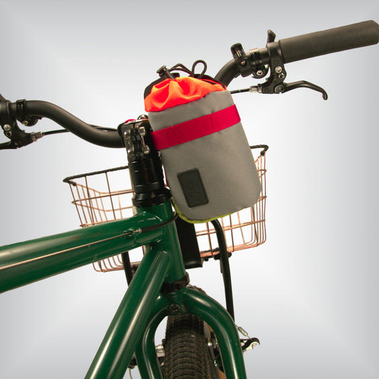 A grey and light green stem bag with a drawstring closure attached to MTB bicycle's handlebars. 