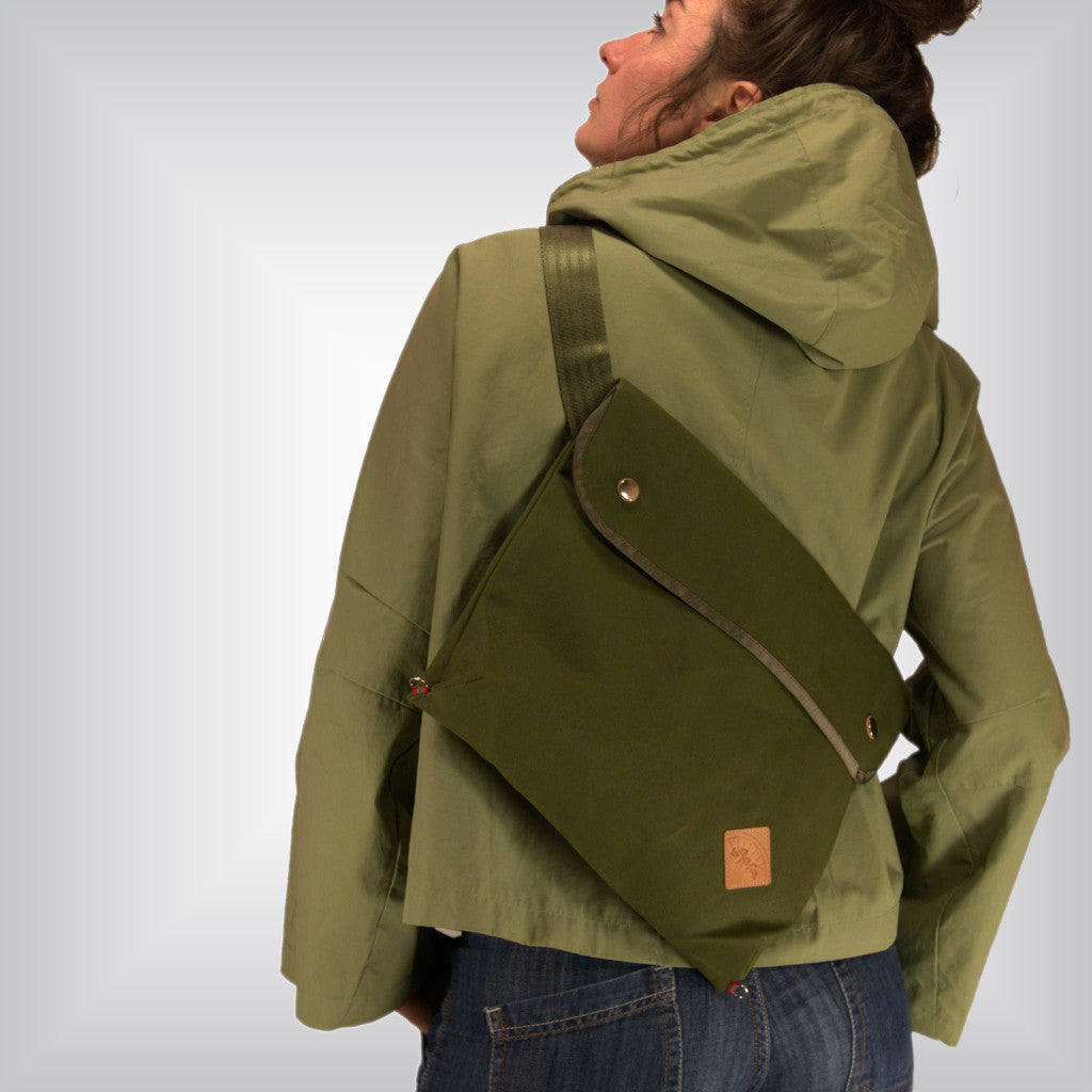 Woman wearing green flat casual canvas crossbody bag